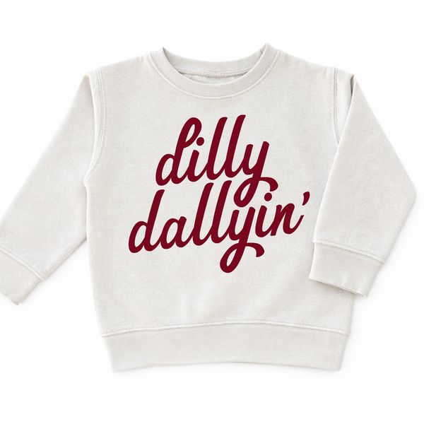Cream toddler boys sweatshirt featuring red "Dilly Dallyin'" script graphic, trendy fall sweatshirt for boys and toddlers.