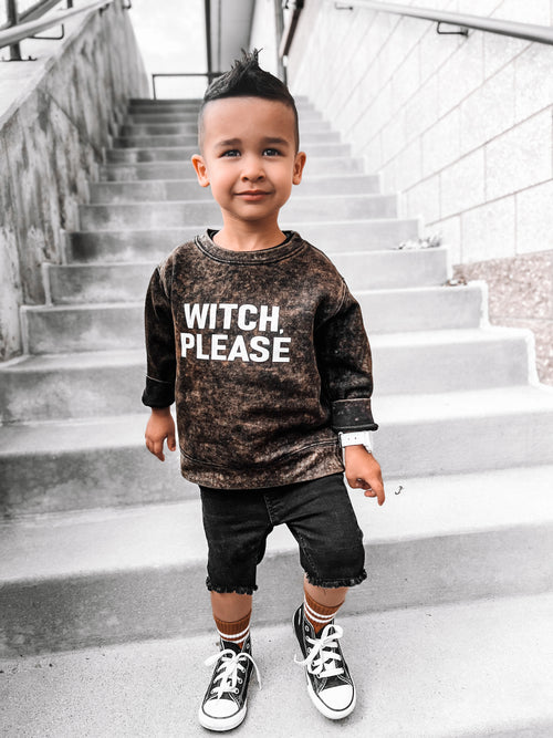 Toddler boy wearing a vintage wash Halloween sweatshirt with Witch Please graphic, styled with black denim shorts and sneakers for a trendy fall outfit.